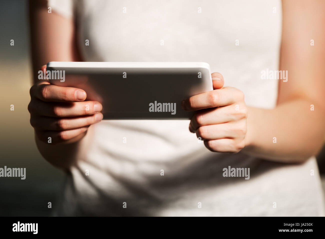 Female hands holding a digital tablet computer Stock Photo