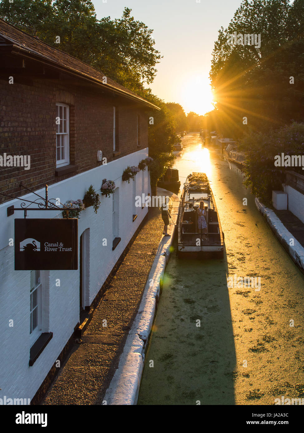 London, England - July 19, 2016: A narrowboat passes the Canal & River Trust offices at Little Venice in Paddington, Central London. Stock Photo