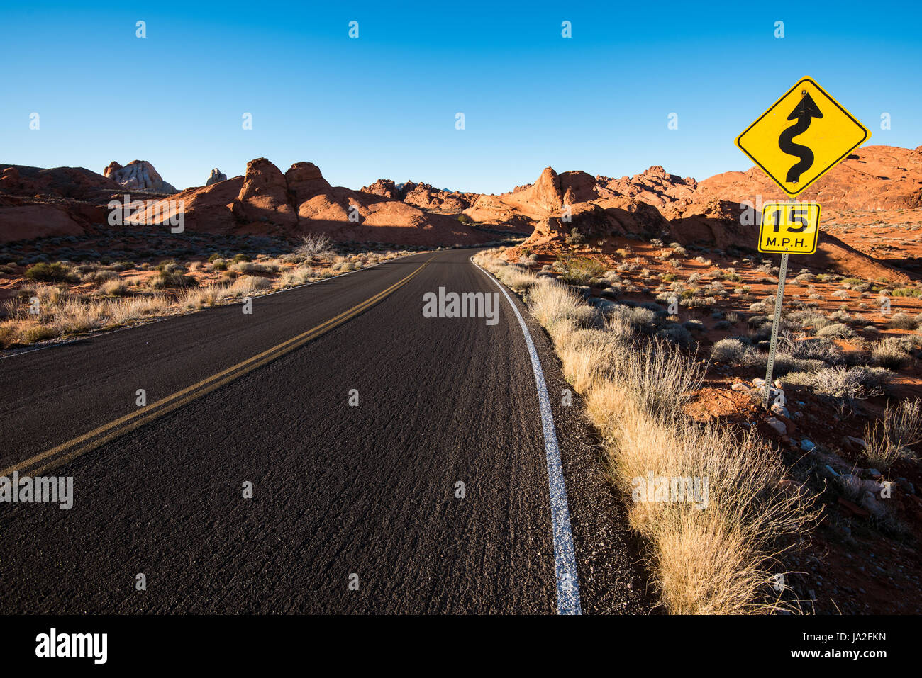 A 'curves ahead' sign on a desert road. Valley of Fire State Park, Nevada. Stock Photo