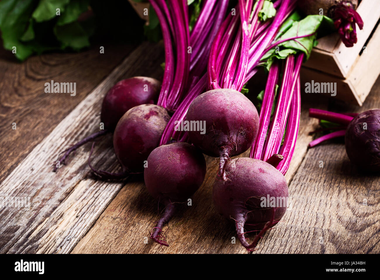 Organic  farm. Fresh beetroot in crate, vegetables on rustic wooden background Stock Photo