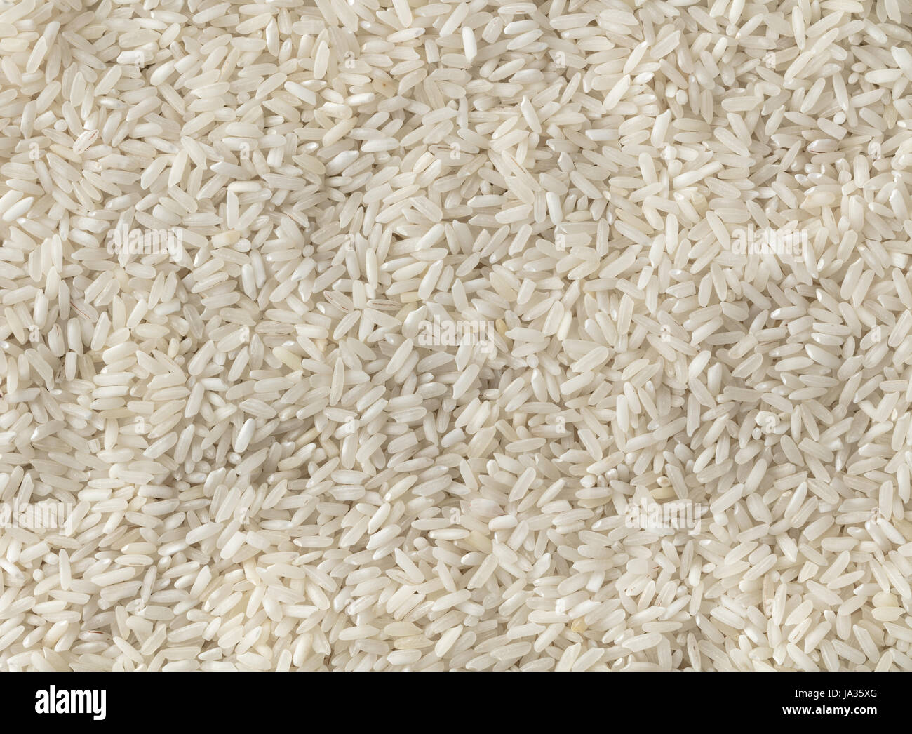 abstract background texture of uncooked rice closeup Stock Photo - Alamy