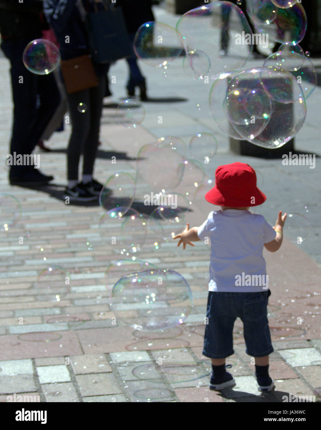 little boy in red hat sunny day Stock Photo