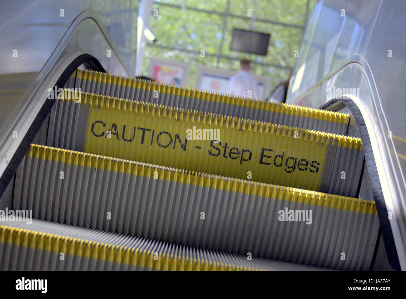 escalator steps caution step edges sign Stock Photo