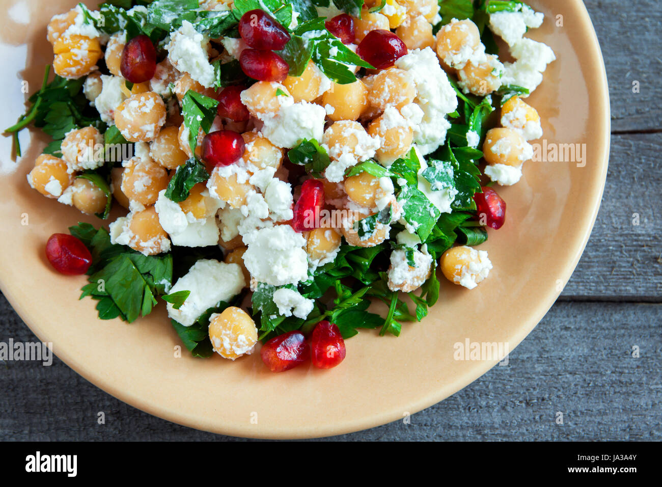 Chickpea salad with fresh feta cheese, parsley and pomegranate seeds