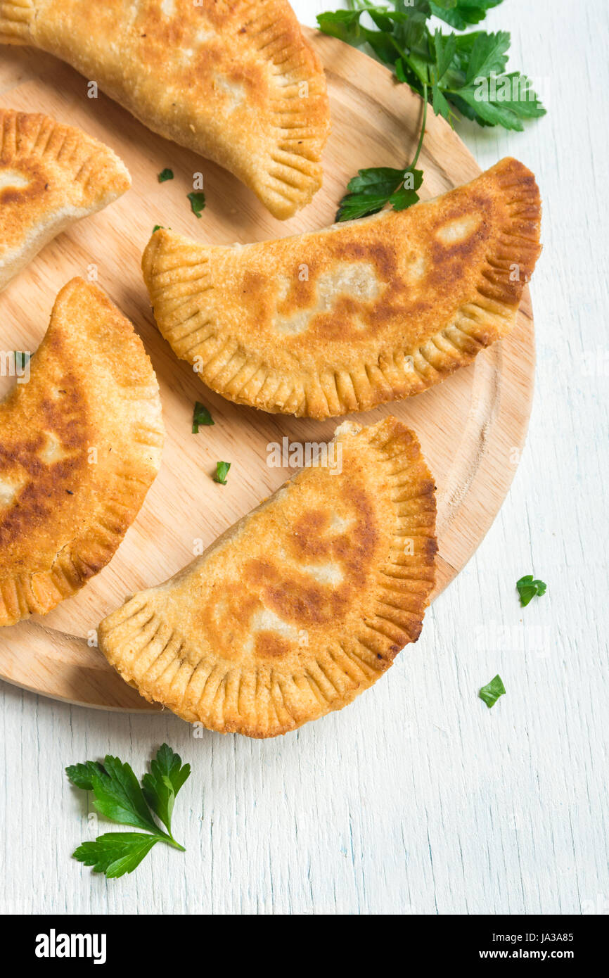 Homemade deep fried vegetable burekas (patties, samosas) on white background vegetarian fried