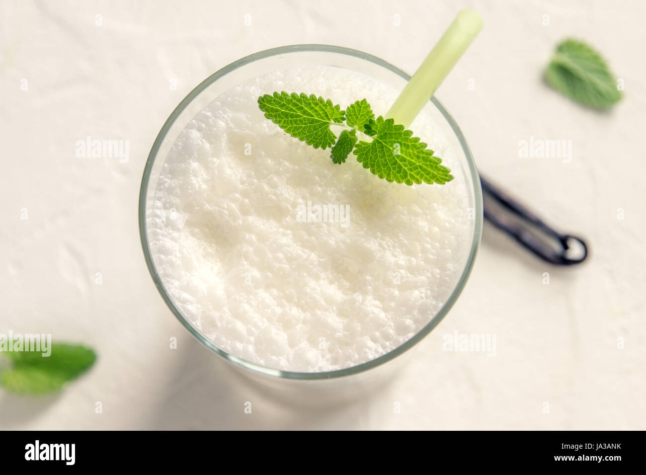 Vanilla Shake with Mint on white background. Vanilla Ice Cream Milk
