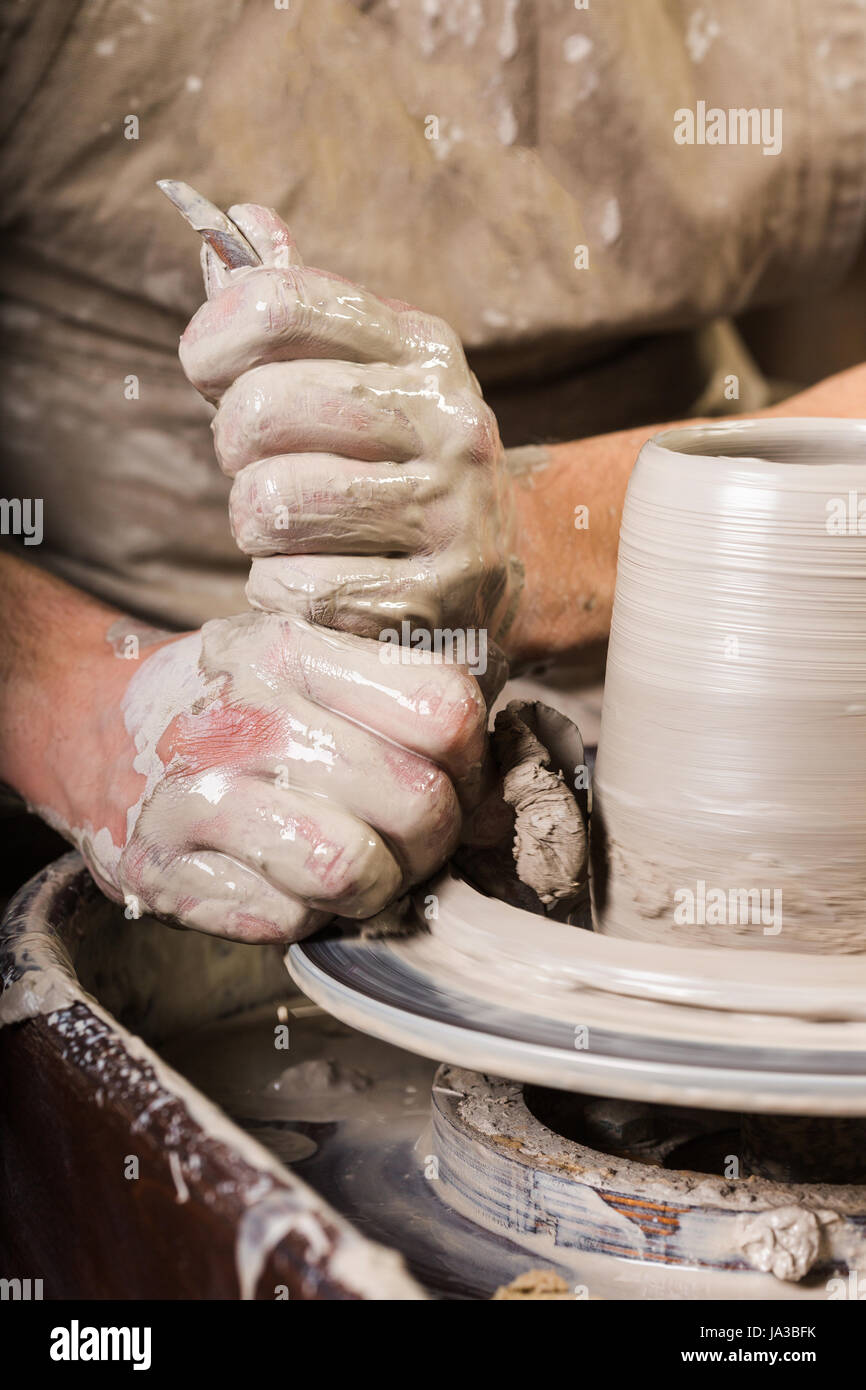 pottery, ceramics art concept male master sculpt a utensil