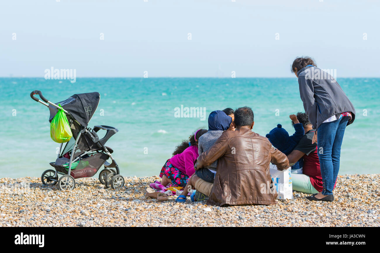 Asian family at the seaside on a beach. Stock Photo