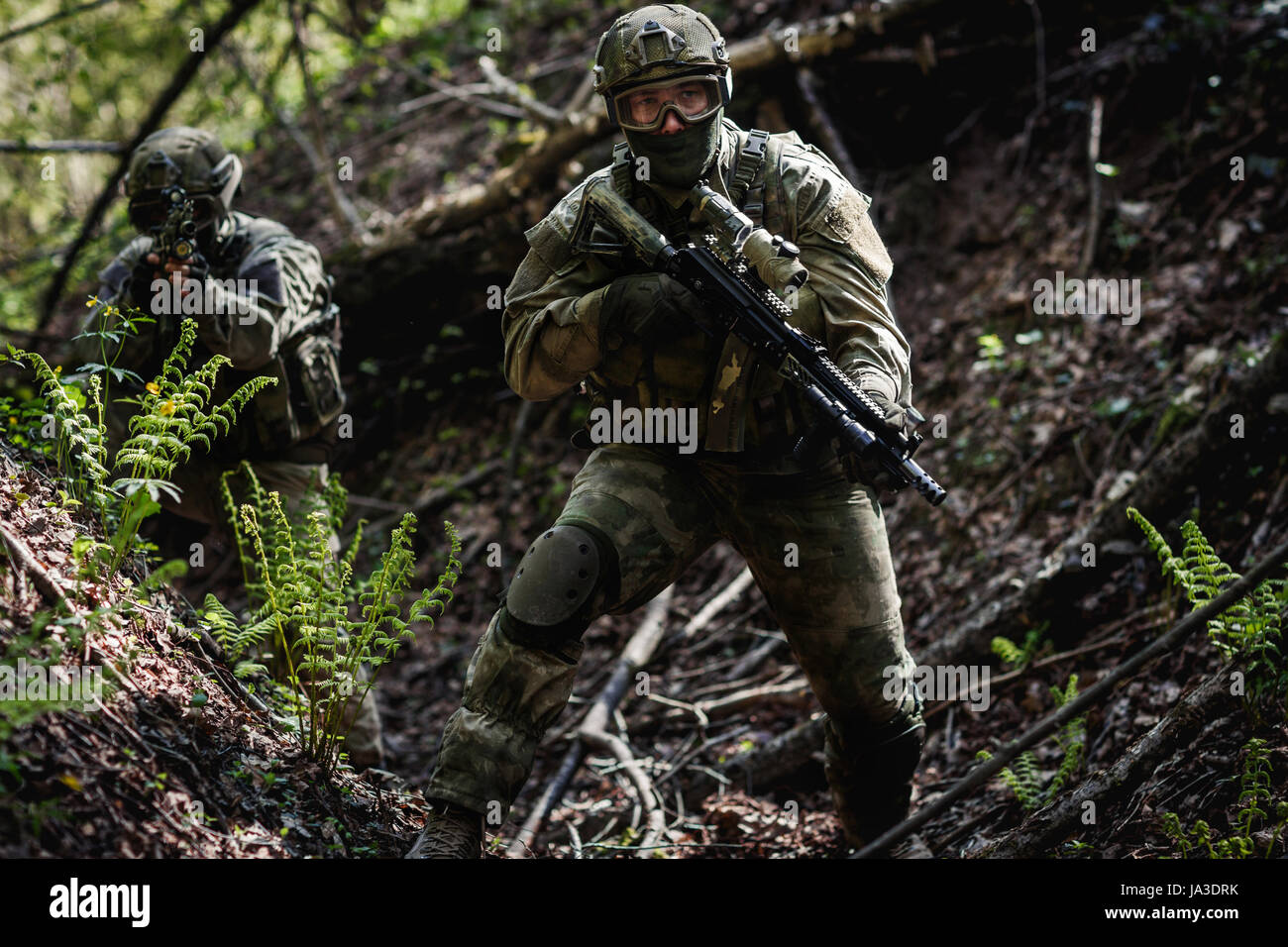 One soldier among trees on military mission during day Stock Photo