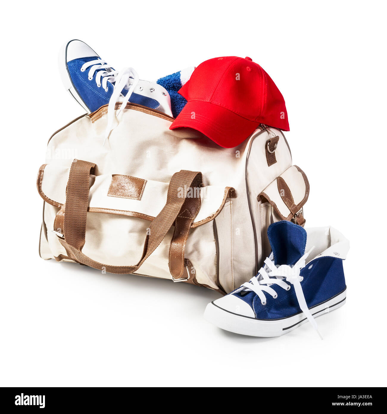 Bag with sport shoes and baseball cap isolated on white background clipping path included. Healthy lifestyle concept Stock Photo