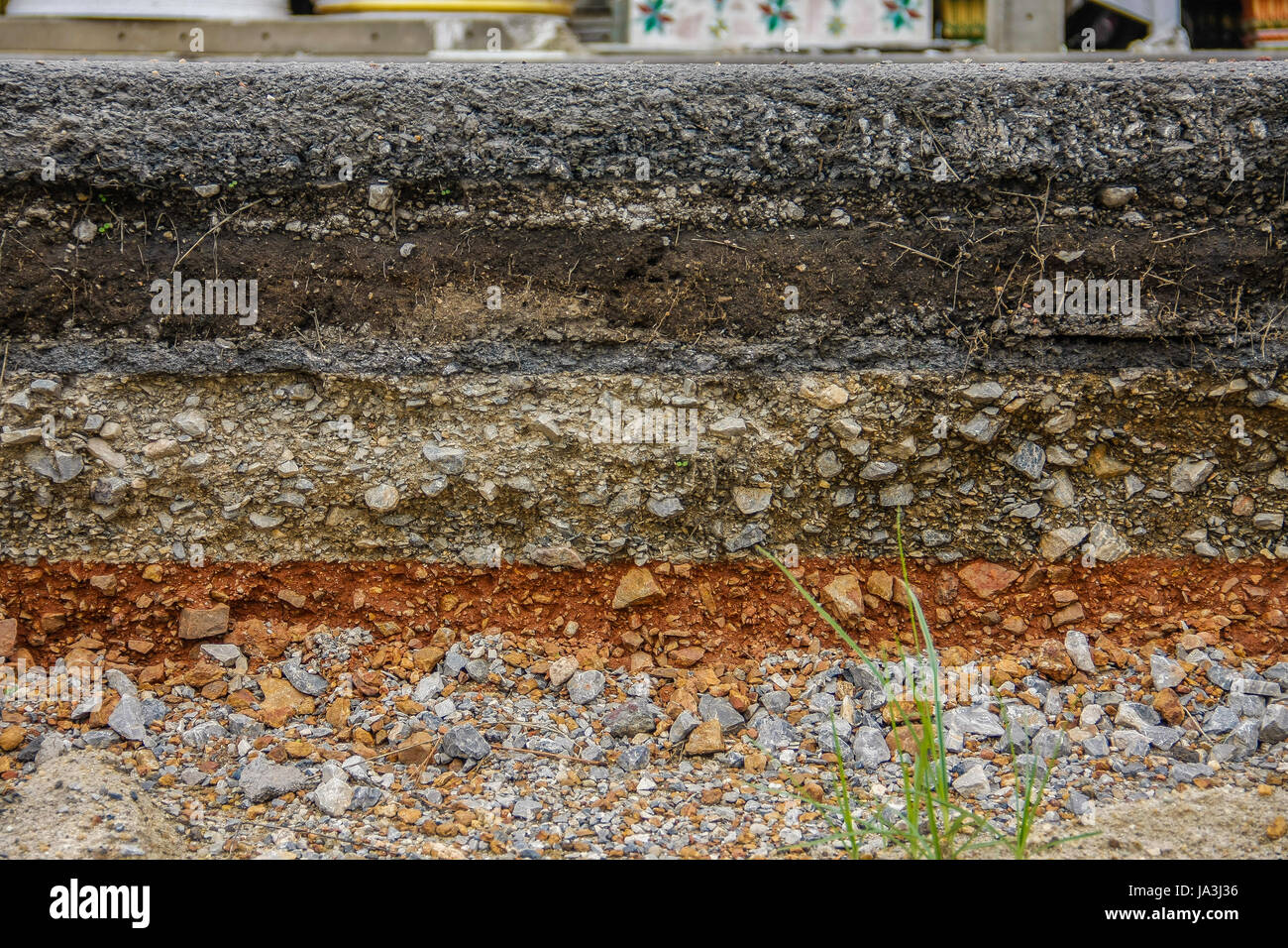 construction of black asphalt layer road with soil and stone Stock