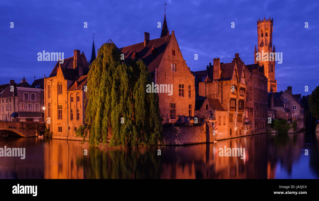 Bruges, Belgium. Famous photo spot 'Huidenvetters plein', with Dijver river canal during twilight and Belfort (Belfry) tower. Stock Photo