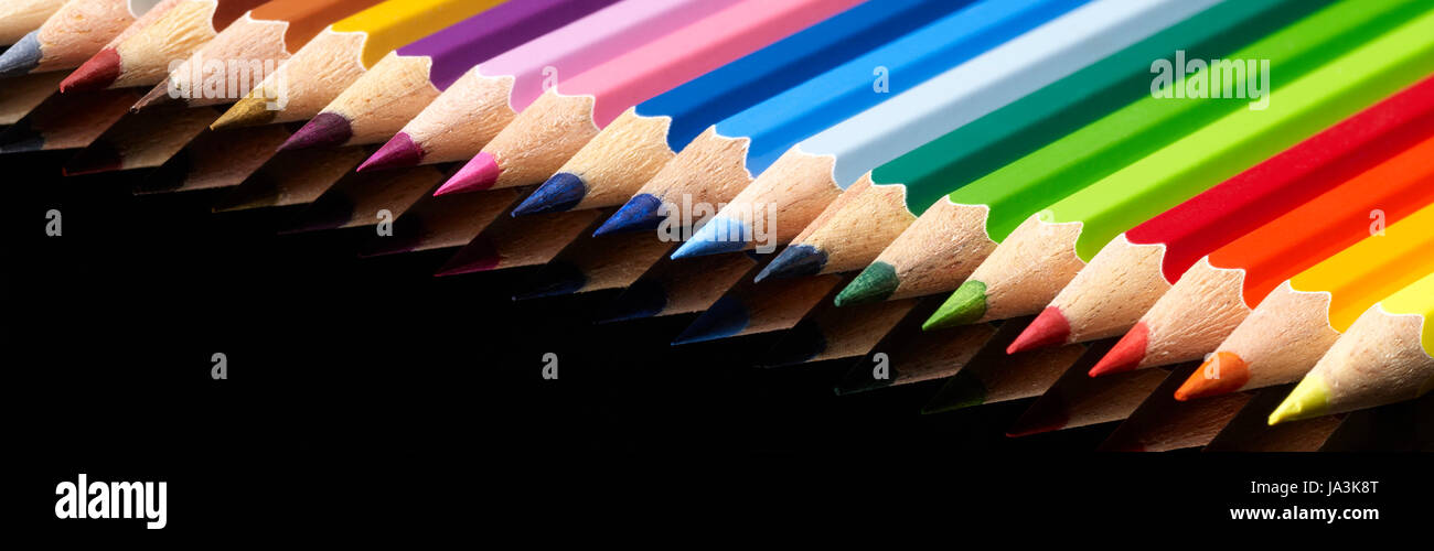 lots of colorful pencils in black reflective back Stock Photo