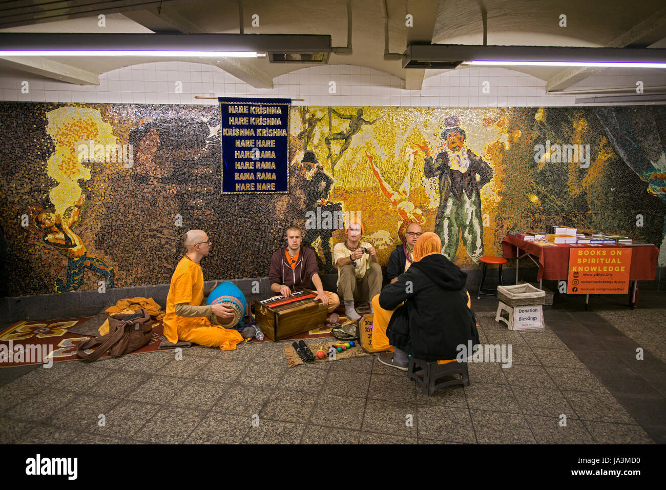 Hare Krishna devotees chanting and soliciting donations at the 34th Street subway station in Manhattan, New York City. Stock Photo