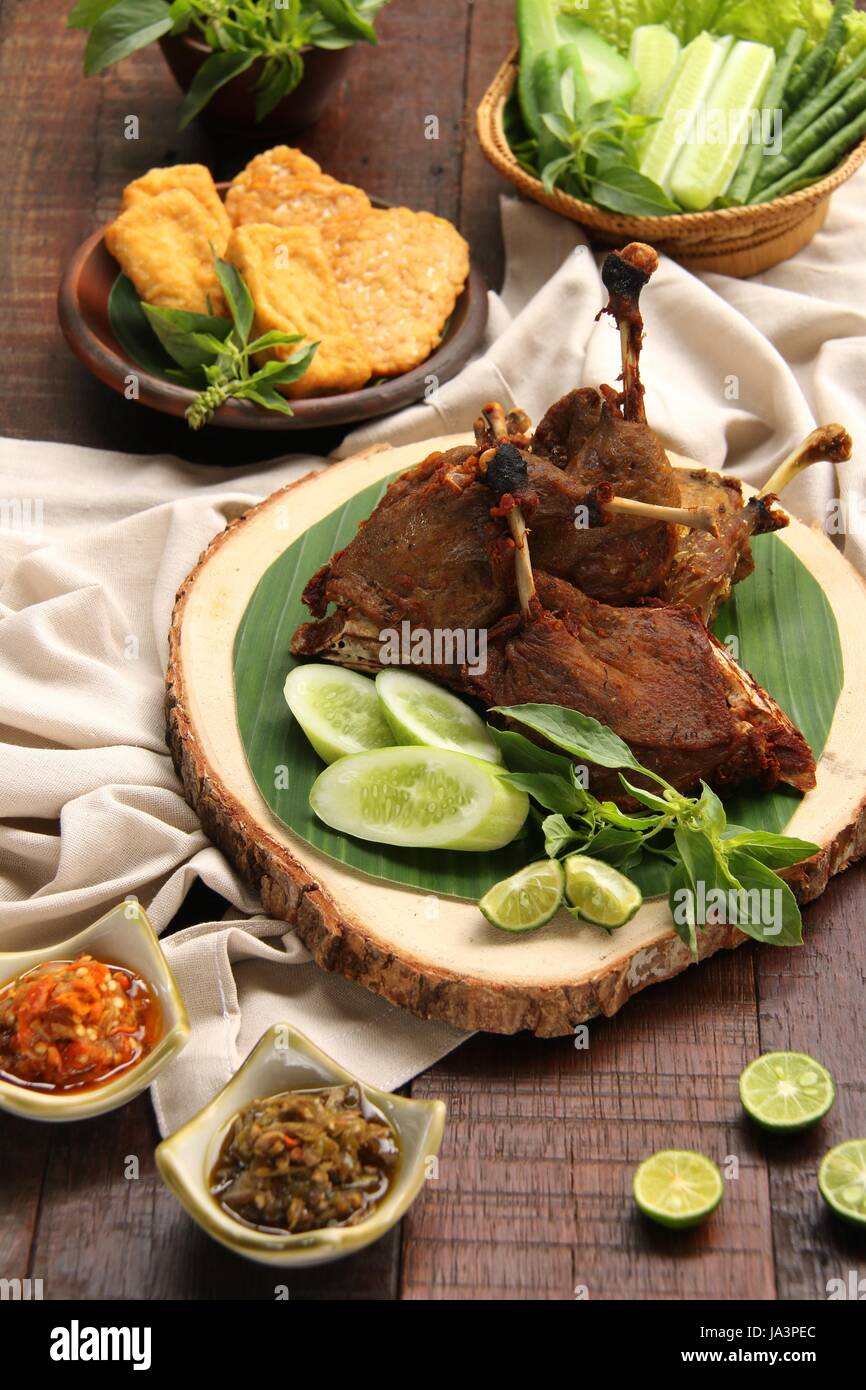 Bebek Goreng A Popular Indonesian Dish Of Fried Duck Served With Beancurd Tempeh Vegetables And Chili Pastes Stock Photo Alamy
