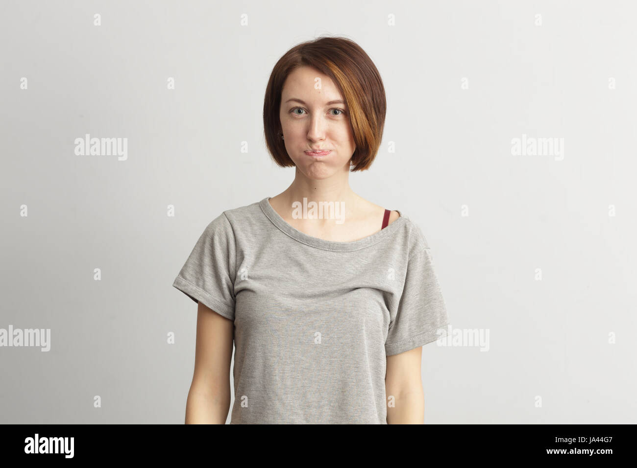 Girl puffed out her cheeks. She is offended and dissatisfied. Stock Photo