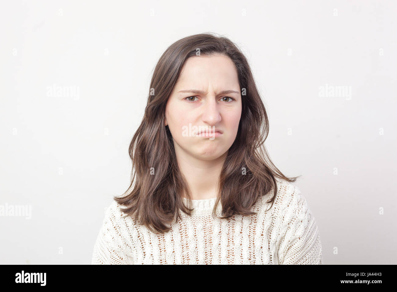 Dissatisfied girl negatively and disgusted looks forward. The negative attitude to something Stock Photo