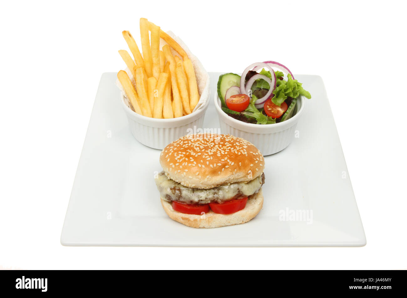 Cheeseburger with salad and fries in ramekins on a square plate isolated against white Stock Photo