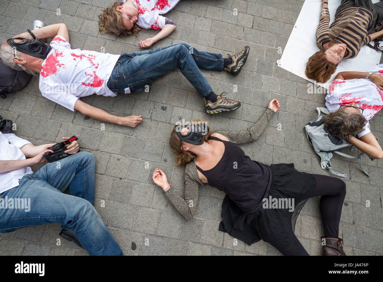 Demonstrators stage a ‘die-in’ protest. Stop the Arms Fair. Anti-war protesters outside Parliament Buildings in London, UK. Stock Photo
