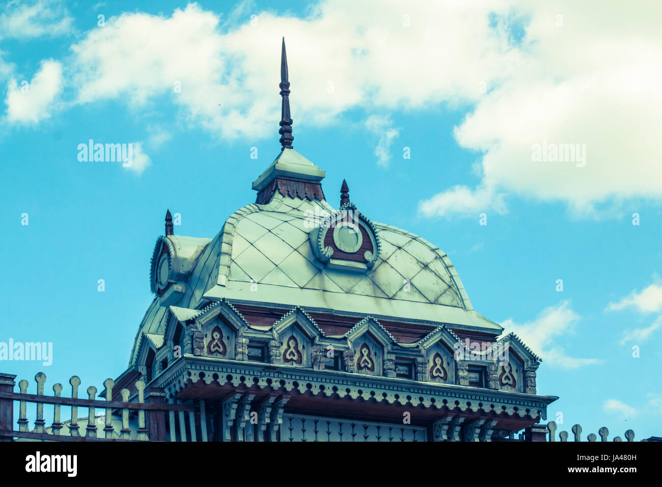 Roof of an ancient building with elements of wood carving on the sky background Stock Photo