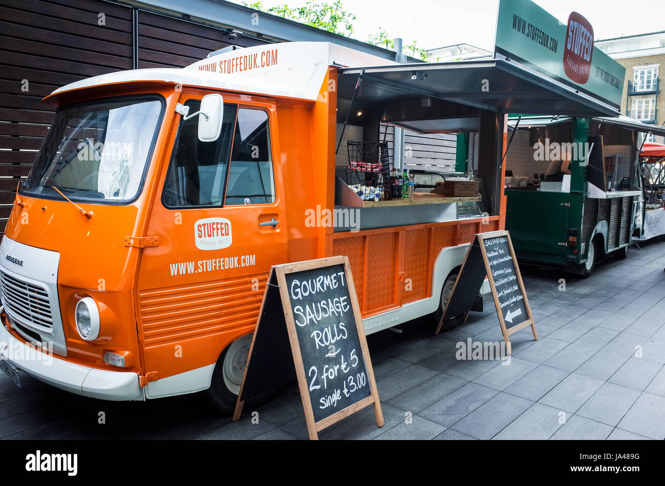 Street Food vans prepare for the lunchtime rush of city workers in Spitalfields Market, Central London Stock Photo