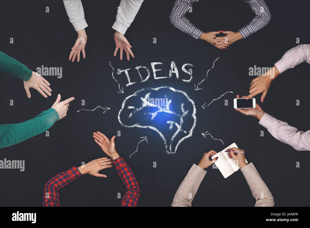 Teamwork concept - top view of six people generate ideas. Stock Photo
