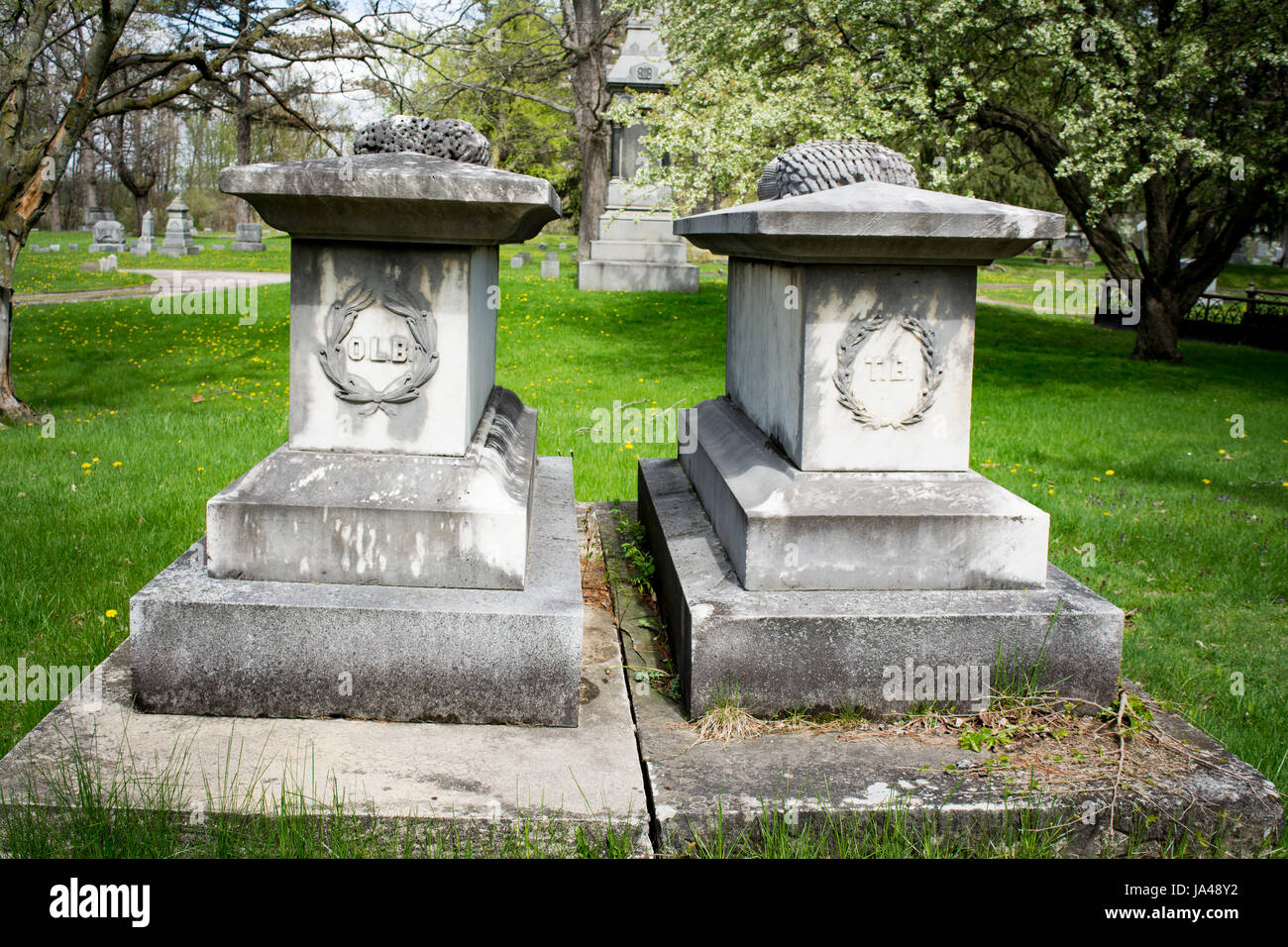 two very large grave markers with decorative initials on them Stock