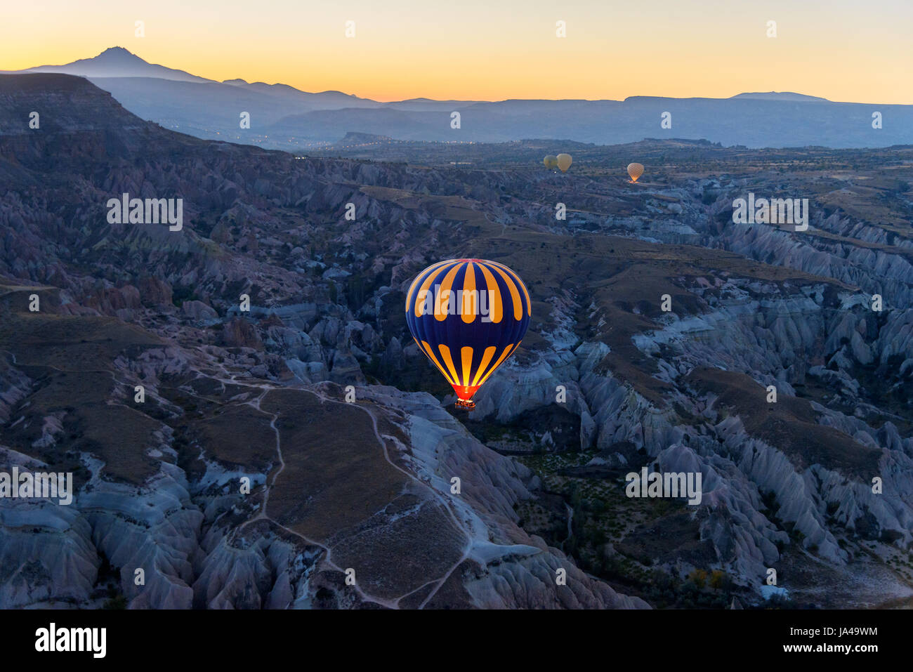 Hot air balloons flying over valley of Cappadocia at sunrise. Nevsehir ...