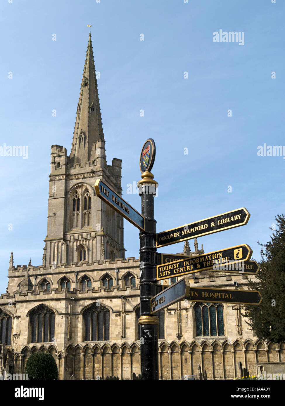 All Saints Church Stamford with finger post direction sign in foreground, Red Lion Square, Stamford, Lincolnshire, England, UK. Stock Photo