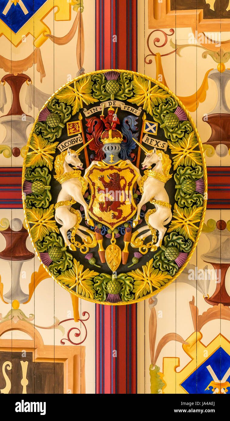 Close up of painted wood carved ceiling rose in King James bedchamber, Royal Palace, Stirling Castle, Scotland, UK, with Scottish royal coat of arms Stock Photo