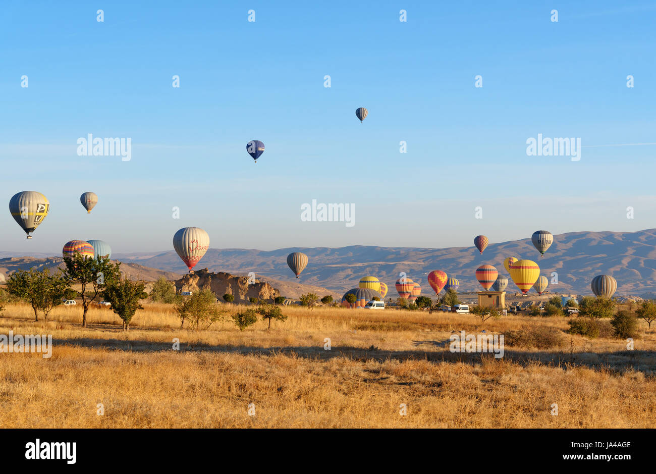 Goreme, Turkey - October 16, 2016: Hot air balloons landing after flight over valley of Cappadocia in the morning. Nevsehir Province. Turkey. Stock Photo