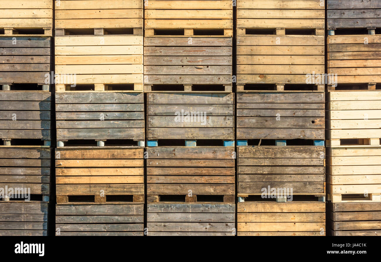 Stack of used wooden crates or boxes. Stock Photo