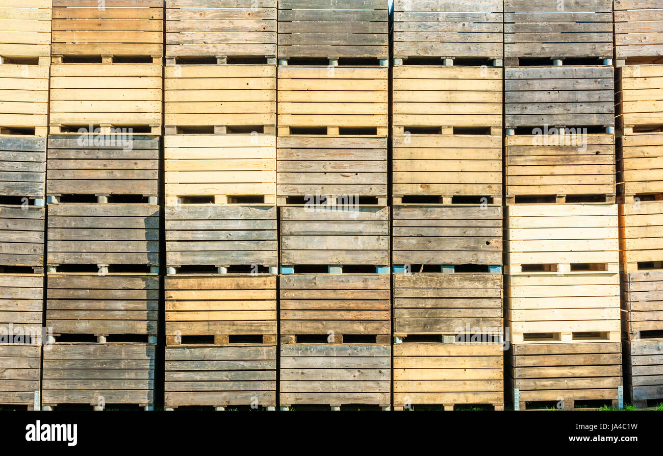 Stack of used wooden crates or boxes. Stock Photo
