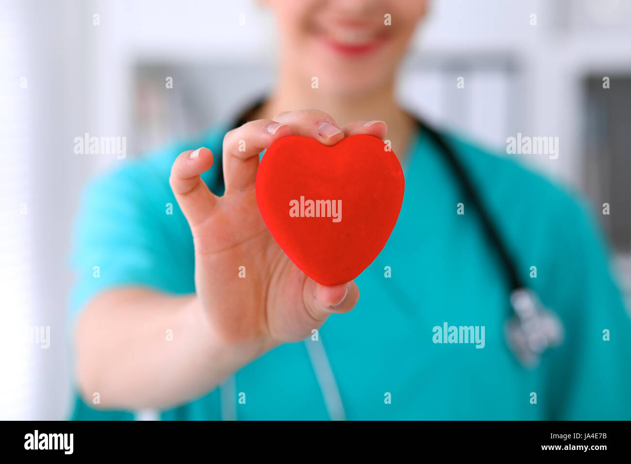 Female surgeon doctor with stethoscope holding heart Stock Photo - Alamy