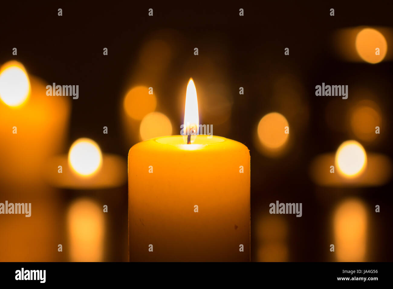 candle flame glowing in the darkness Stock Photo