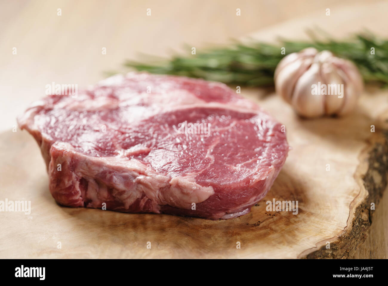 raw rib eye steak on board closeup Stock Photo