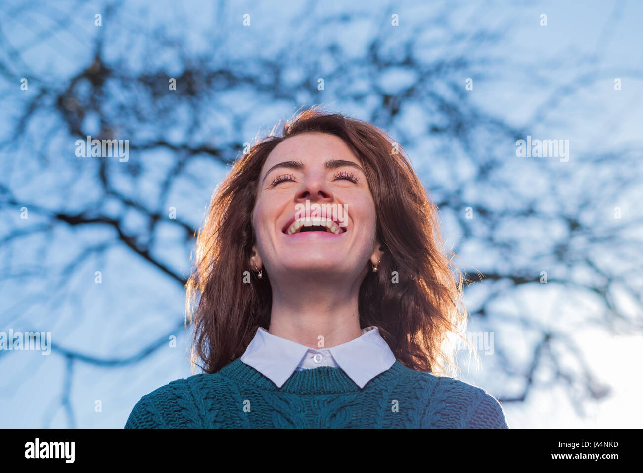 Portrait of a woman with her hand behind her head hires stock