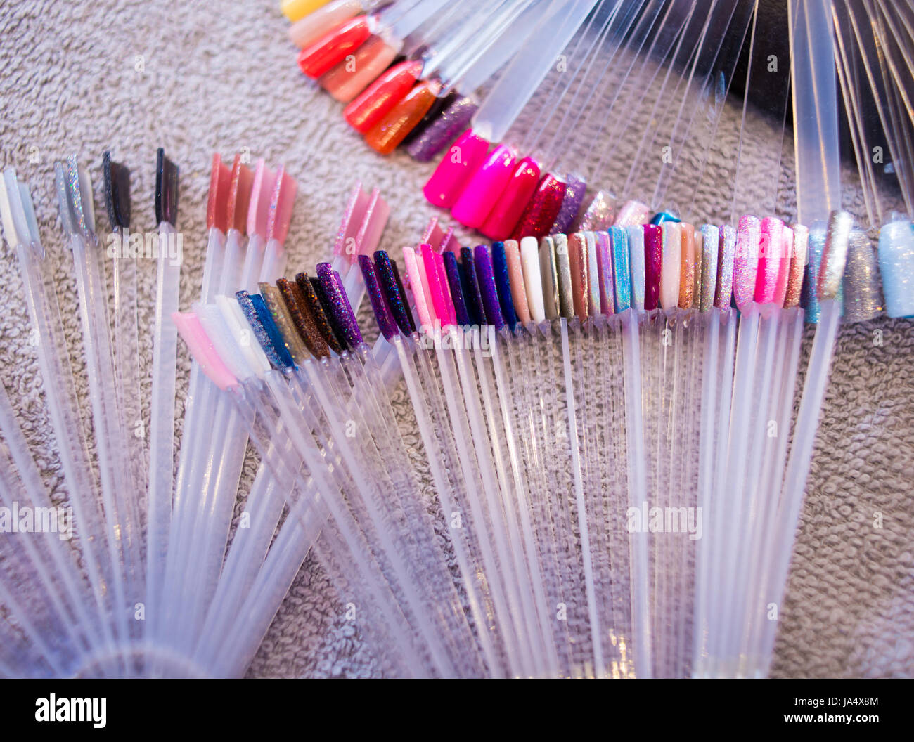 Colourful selection of nail polish colour options on display in a nail salon. Stock Photo