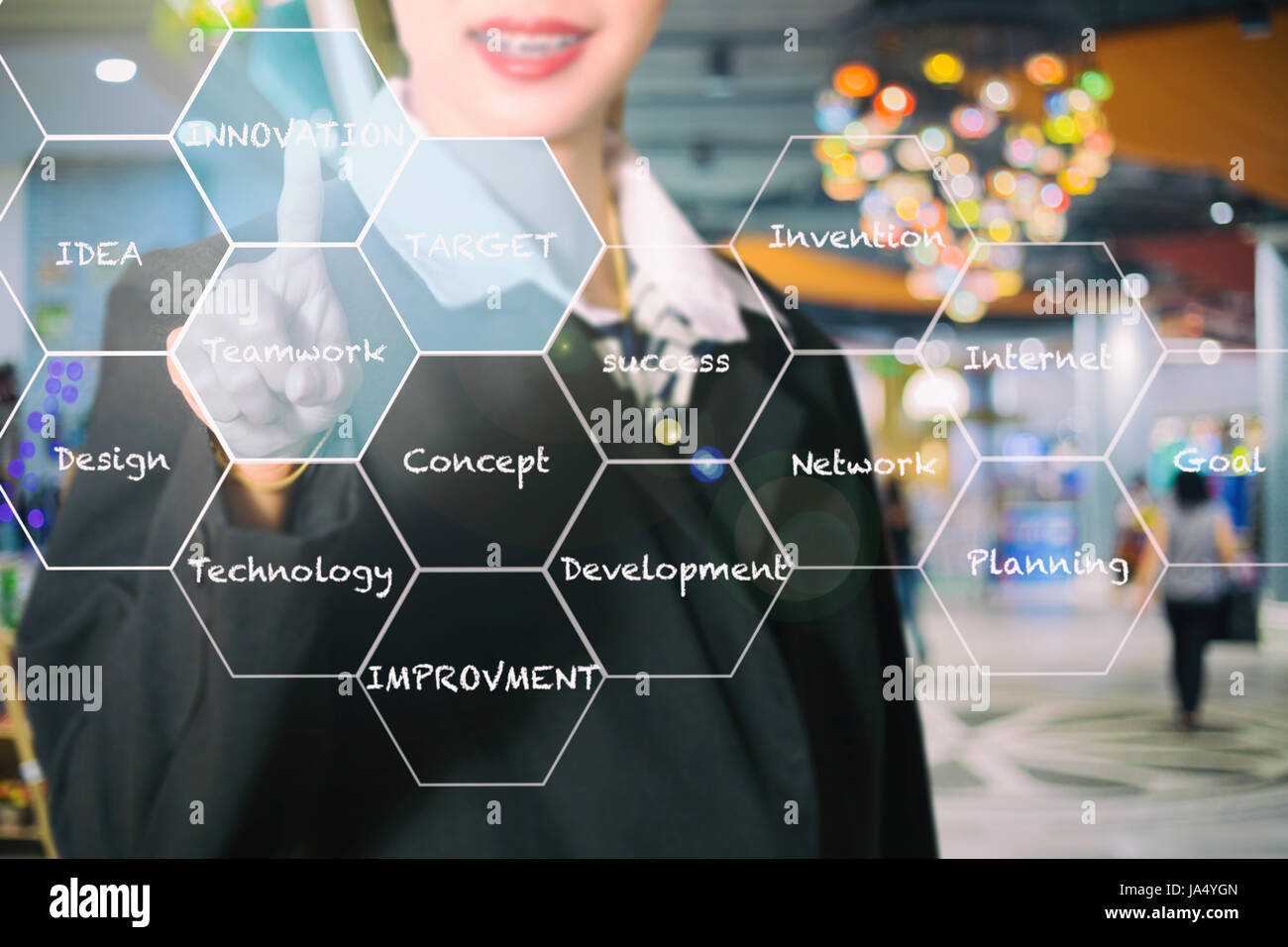 Asian Businesswomen holding hand and touching on virtual screen Innovation concept presented by a consultant in management Stock Photo