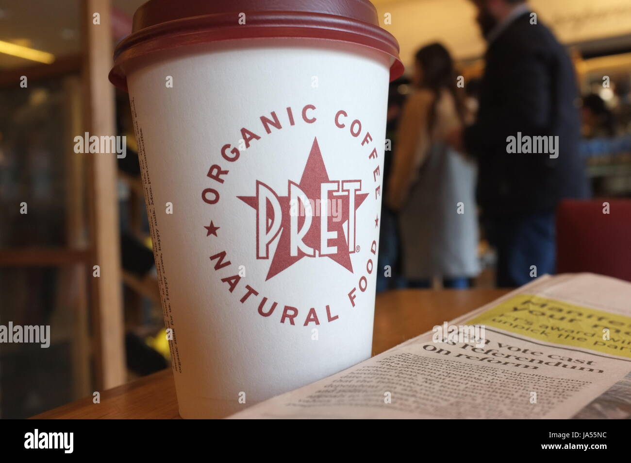 A Pret a Manger coffee cup on a table in Notting Hill, London, England, United Kingdom. May 2017. Stock Photo