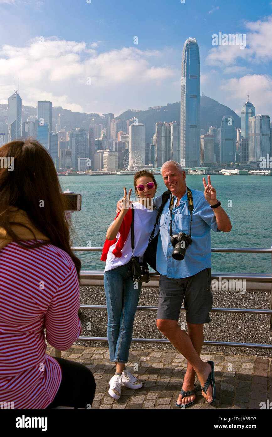 Vertical view of tourists taking photos of the dramatic skyline of Hong Kong Island, China. Stock Photo