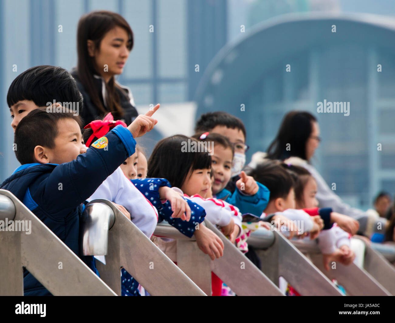 Horizontal view of a group of children looking at the view in Hong Kong, China. Stock Photo