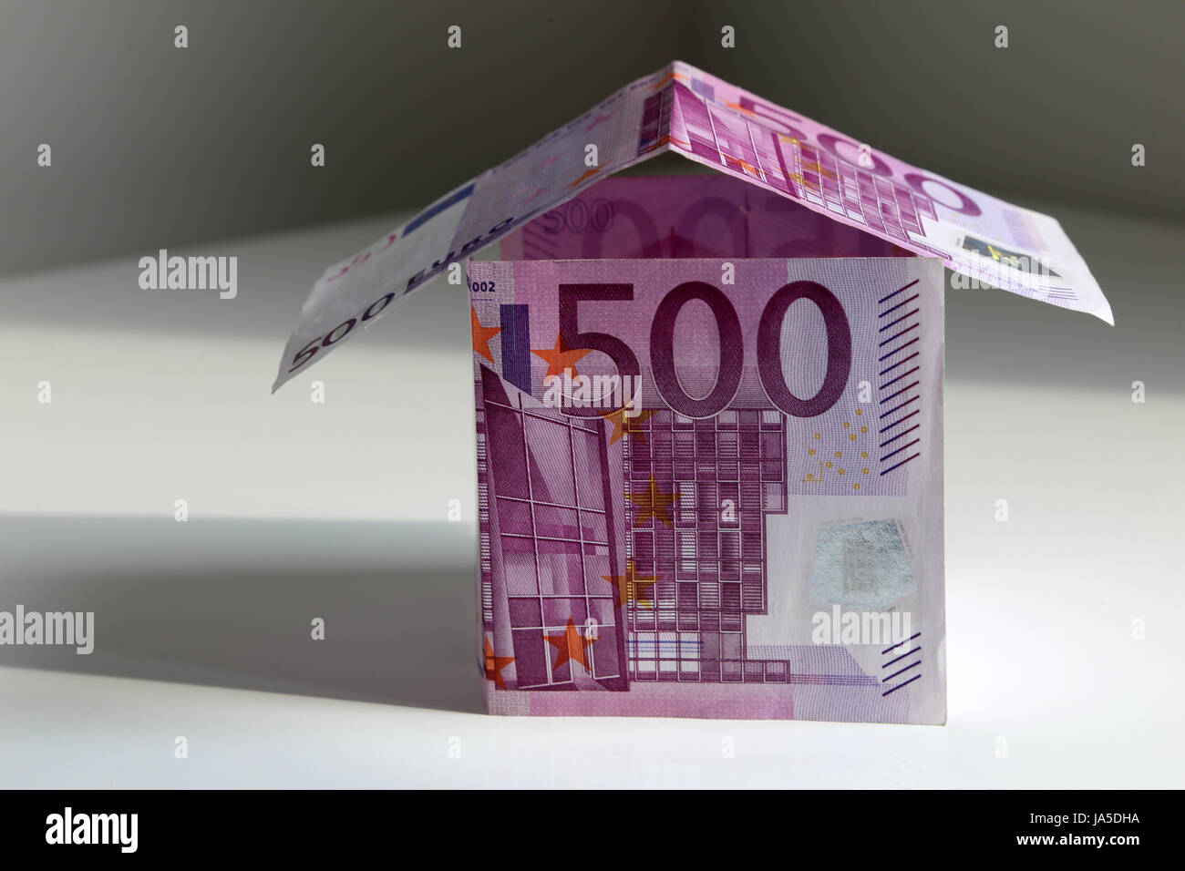 A house bulit from 500 Euro bills, symbol of building a house and paying mortgage Stock Photo
