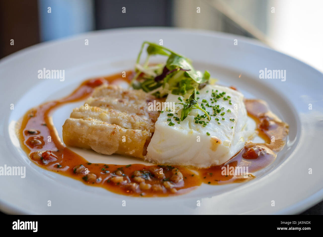 Silver cod, lobster macaroni and  piquillo sauce Stock Photo