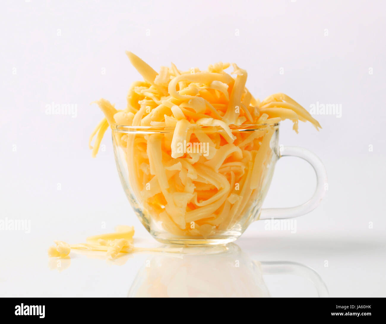 Grated yellow cheese in a glass cup Stock Photo Alamy