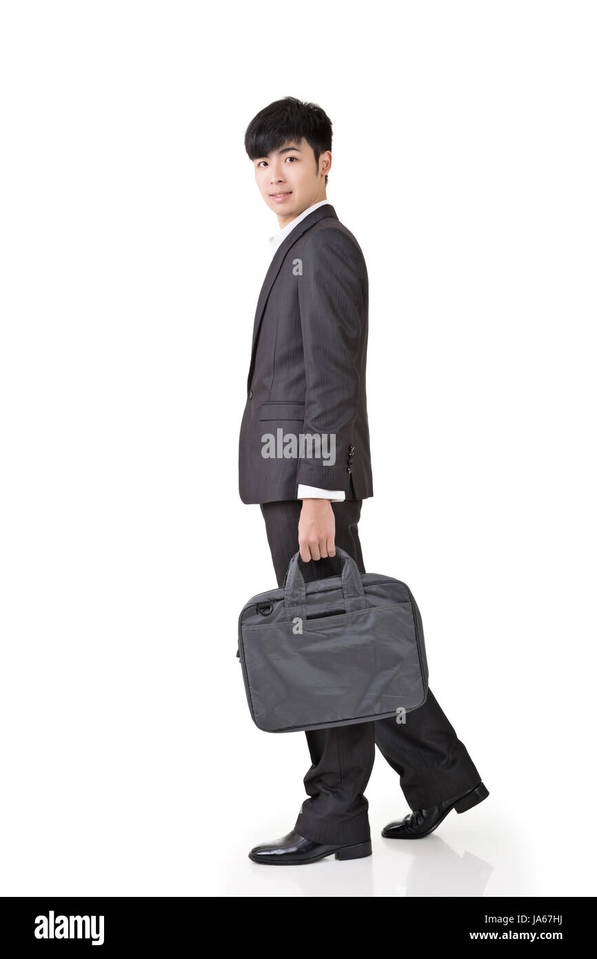 Young businessman hold briefcase and walk, full length portrait