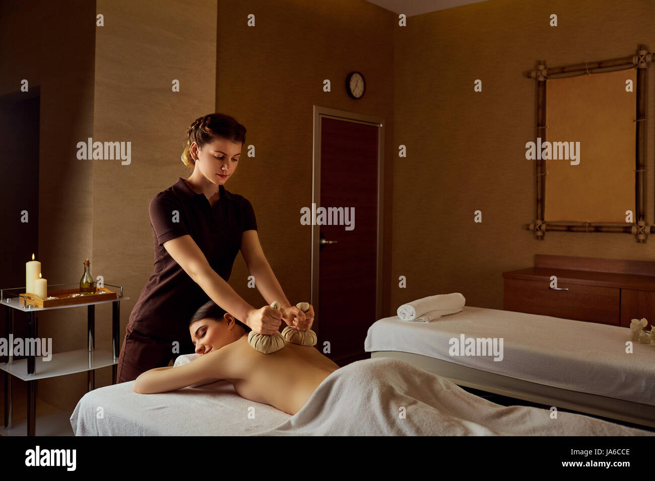 Body massage bags on the back of a girl in  beauty salon spa Stock Photo