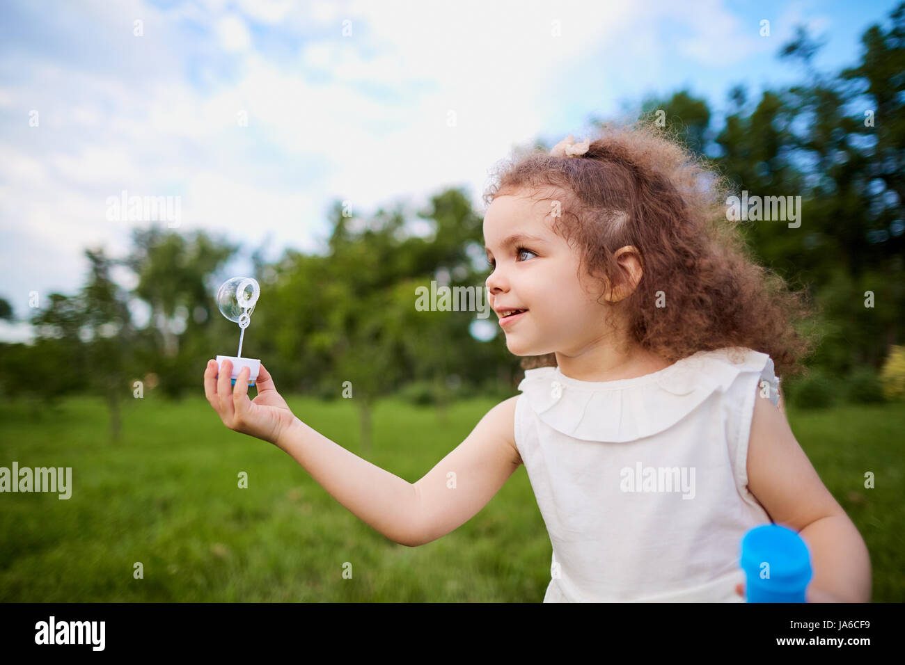 Child is playing with soap bubbles in the park Stock Photo - Alamy