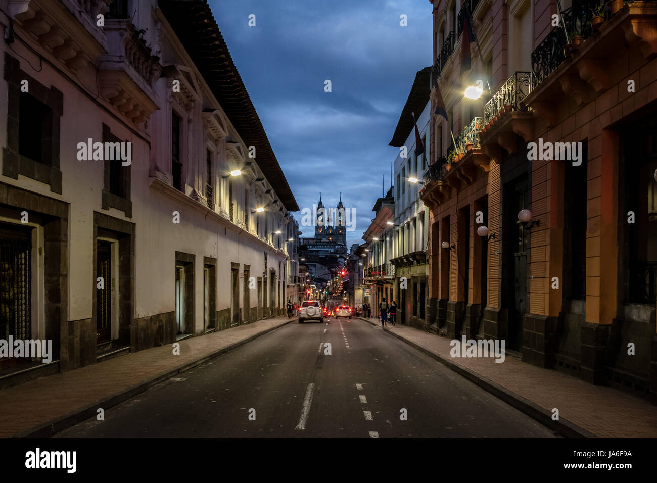 Street of Quito and Basilica del Voto Nacional at night - Quito, Ecuador Stock Photo
