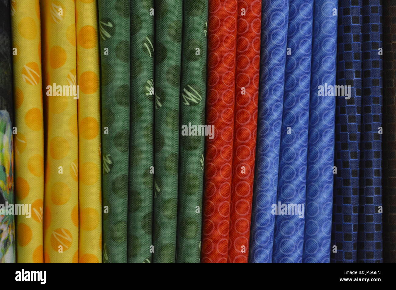 multiple rows of color fabrics folded vertically. Stock Photo